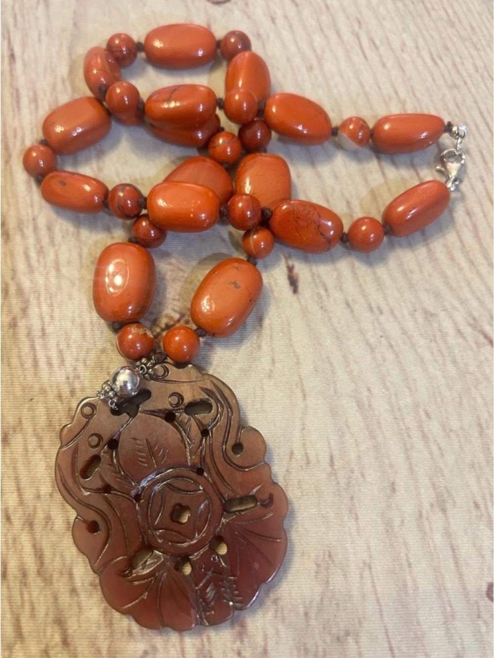 Red River Jasper Gemstone Necklace Featuring Carved Jade Pendant